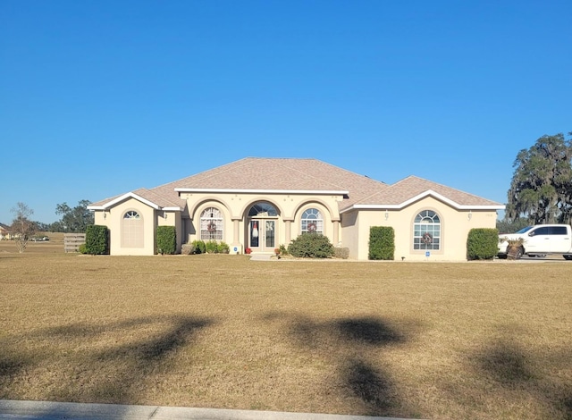 mediterranean / spanish-style house featuring a front lawn