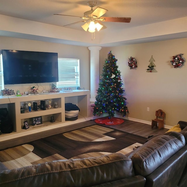 living room with ceiling fan, wood-type flooring, and ornate columns