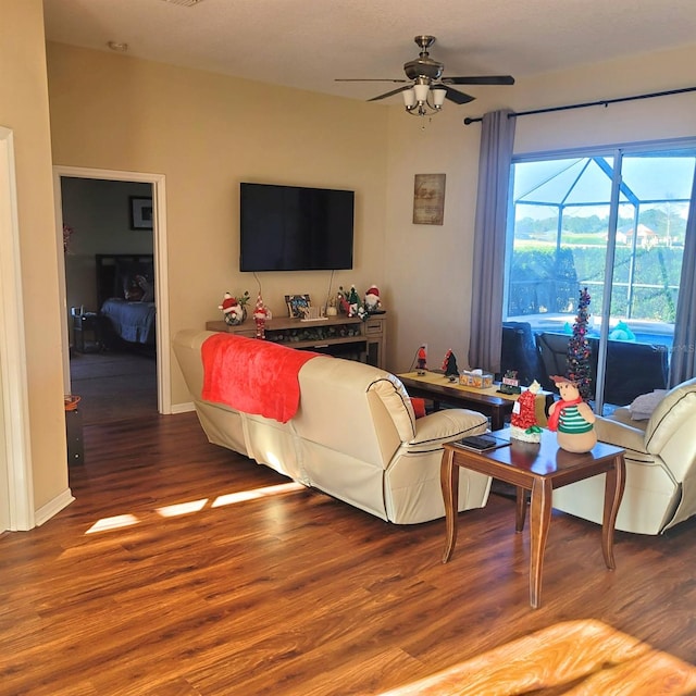 living room featuring ceiling fan and hardwood / wood-style flooring