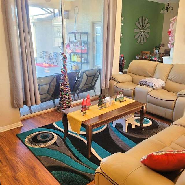 living room featuring hardwood / wood-style floors and an inviting chandelier