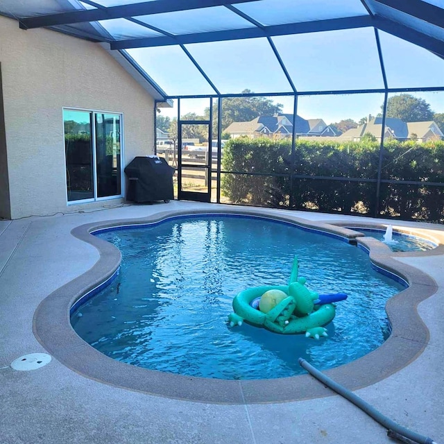 view of pool featuring a grill