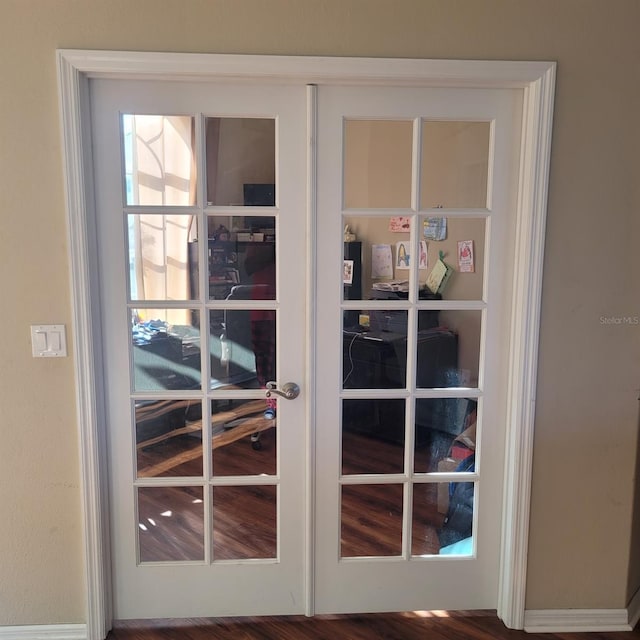 details with french doors and hardwood / wood-style flooring