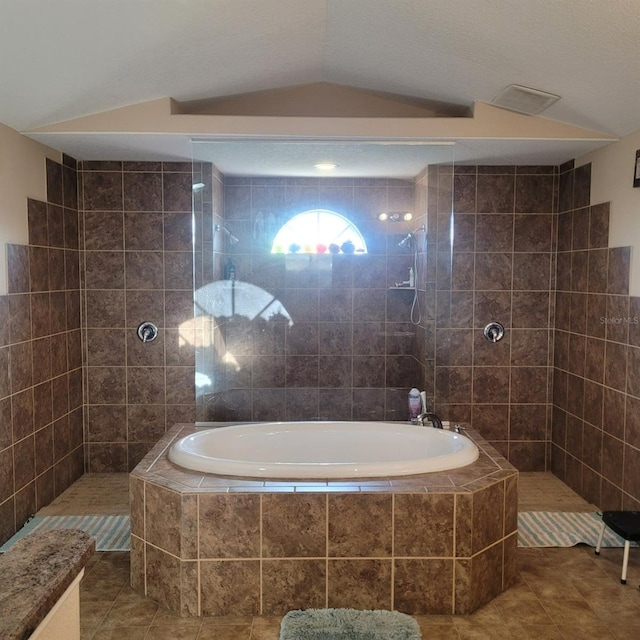 bathroom featuring tile patterned floors, plus walk in shower, and vaulted ceiling