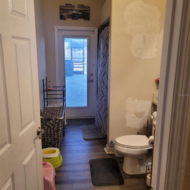 bathroom featuring toilet and hardwood / wood-style flooring