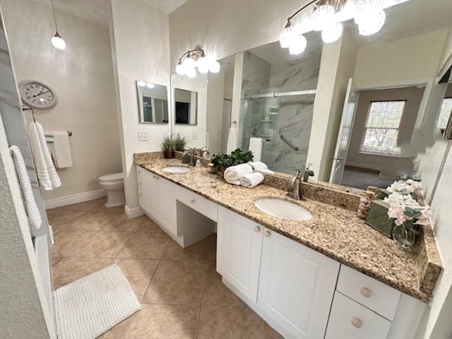 bathroom featuring tile patterned flooring, toilet, vanity, and walk in shower