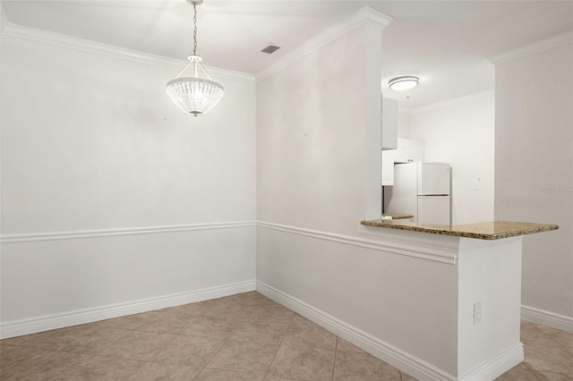 unfurnished dining area with an inviting chandelier, light tile patterned floors, and ornamental molding