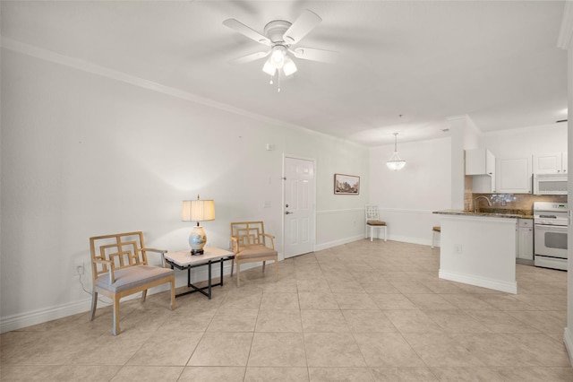 living area with ceiling fan, light tile patterned floors, and crown molding