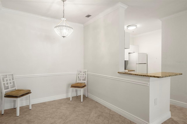 unfurnished dining area featuring ornamental molding and a chandelier