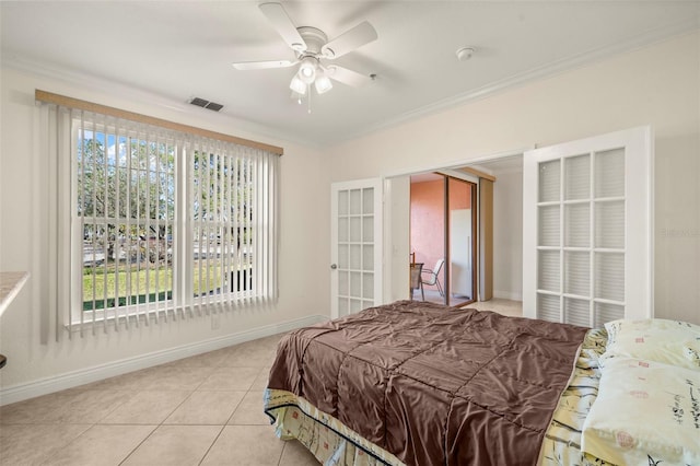 bedroom with multiple windows, ceiling fan, crown molding, and light tile patterned floors