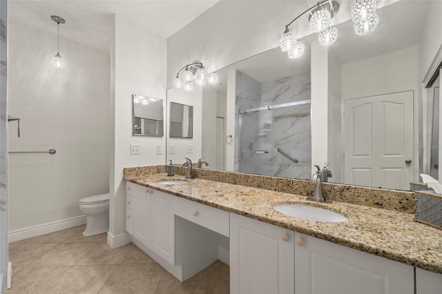 bathroom featuring tile patterned flooring, vanity, toilet, and a shower with shower door