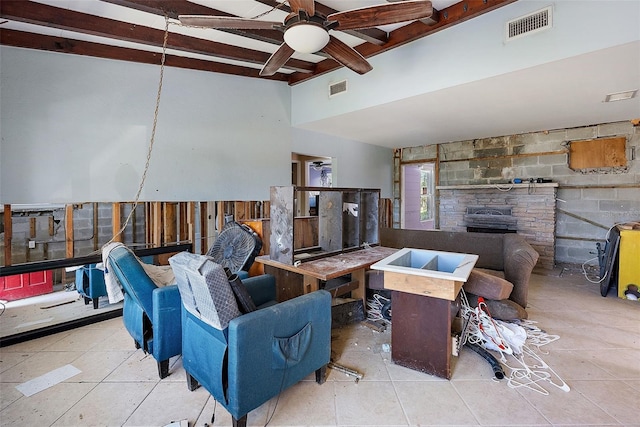 tiled living room with beam ceiling and ceiling fan