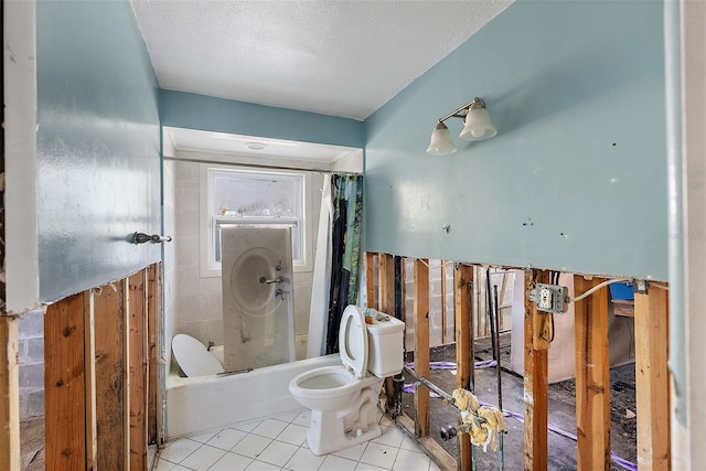 bathroom with tile patterned floors, shower / bath combination with curtain, a textured ceiling, and toilet