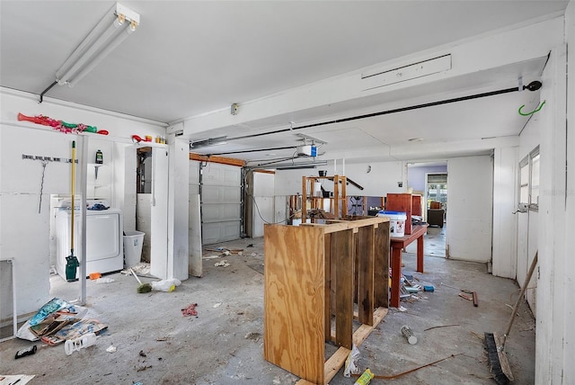 garage featuring washer / clothes dryer and a garage door opener