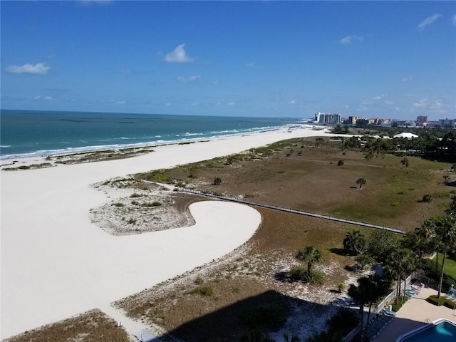 drone / aerial view featuring a water view and a beach view