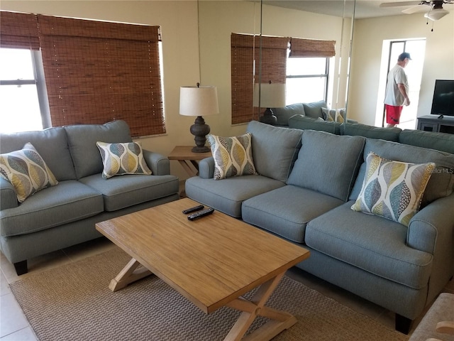 living room featuring ceiling fan and light tile patterned floors