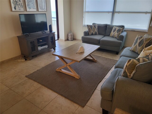 living room with a wealth of natural light and light tile patterned floors