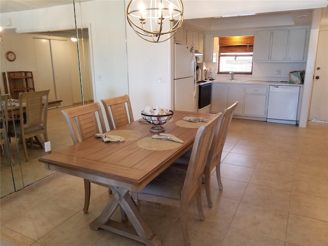 dining room featuring light tile patterned floors, a notable chandelier, and sink