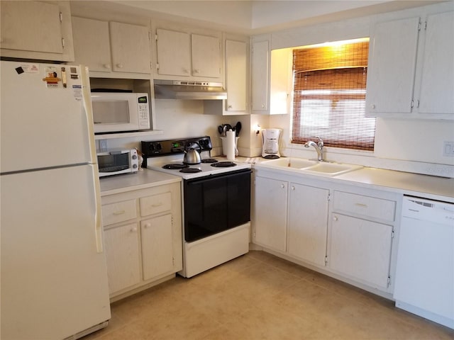 kitchen with white appliances, white cabinetry, and sink