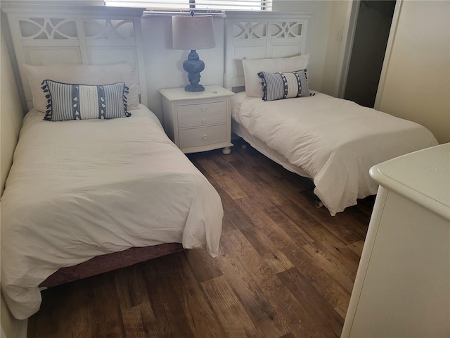 bedroom with dark wood-type flooring