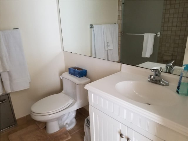 bathroom featuring tile patterned floors, vanity, and toilet