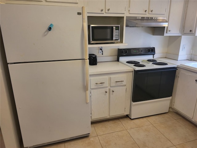 kitchen featuring light tile patterned floors and white appliances