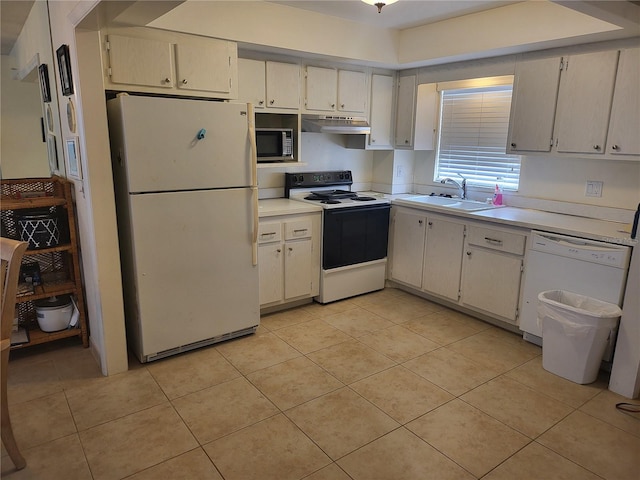 kitchen featuring light tile patterned flooring, white appliances, and sink