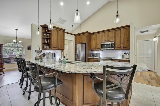 kitchen featuring kitchen peninsula, pendant lighting, and appliances with stainless steel finishes