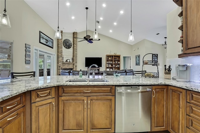 kitchen with pendant lighting, lofted ceiling, sink, stainless steel dishwasher, and ceiling fan