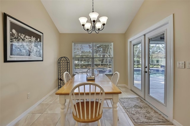 tiled dining space featuring a wealth of natural light, french doors, a chandelier, and vaulted ceiling