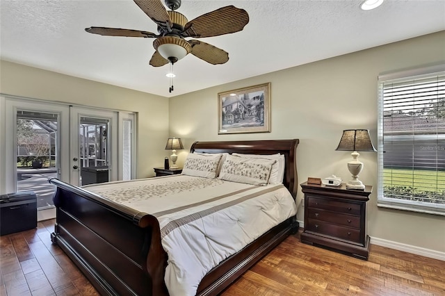 bedroom featuring access to exterior, french doors, a textured ceiling, ceiling fan, and hardwood / wood-style floors