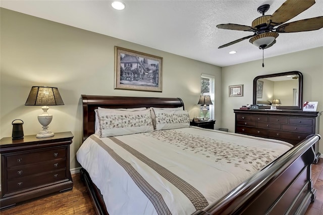 bedroom featuring a textured ceiling, ceiling fan, and dark wood-type flooring