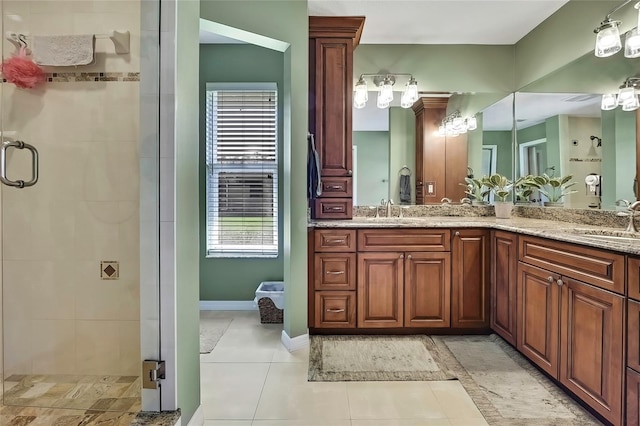 bathroom with tile patterned floors, vanity, and an enclosed shower