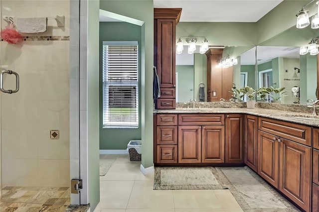 bathroom with tile patterned flooring, vanity, and walk in shower