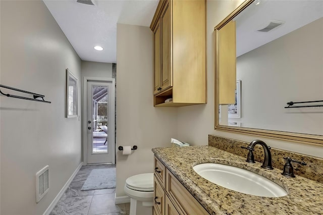 bathroom featuring tile patterned flooring, vanity, and toilet