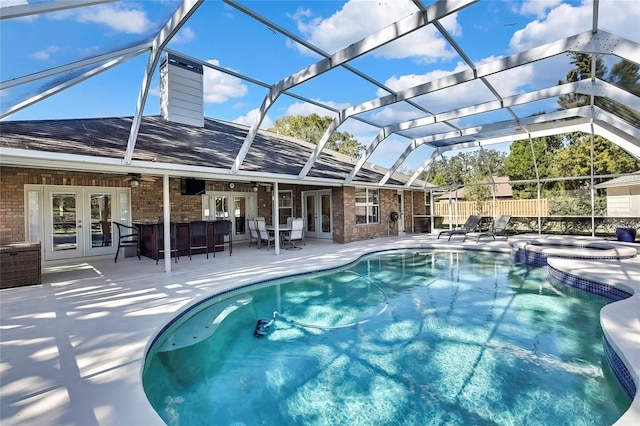 view of pool featuring french doors, a lanai, a jacuzzi, ceiling fan, and a patio area