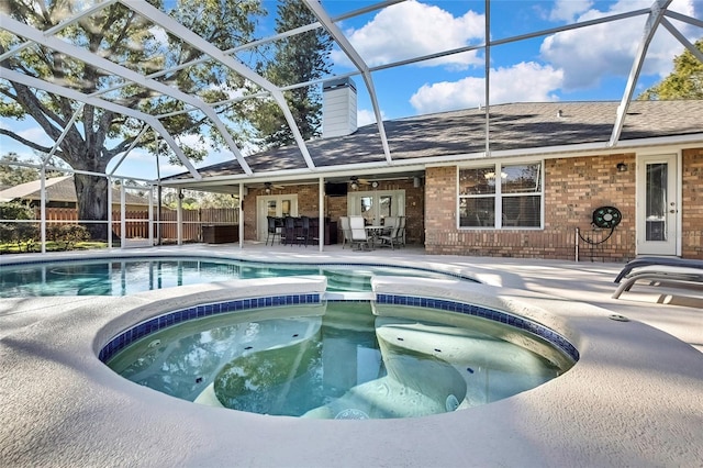 view of swimming pool with an in ground hot tub, a patio, ceiling fan, and a lanai