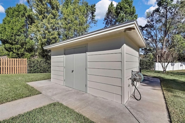 view of outbuilding with a lawn