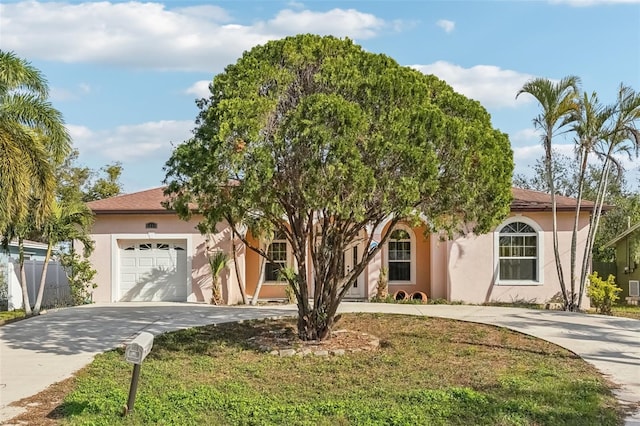 view of front of home featuring a garage and a front yard