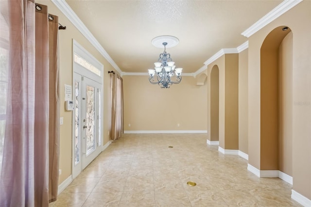 foyer with a chandelier and ornamental molding