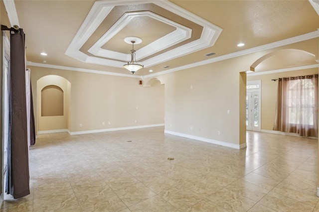 spare room featuring crown molding and a tray ceiling