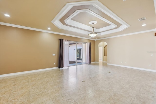 spare room featuring crown molding and a tray ceiling