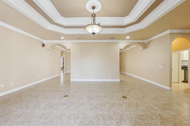 spare room with crown molding and a tray ceiling