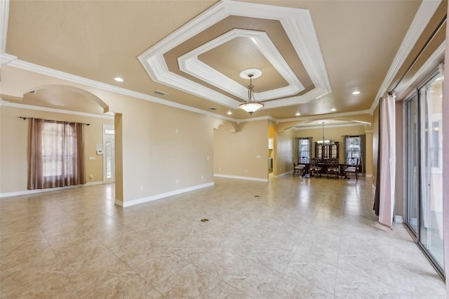 interior space featuring an inviting chandelier, crown molding, and a tray ceiling