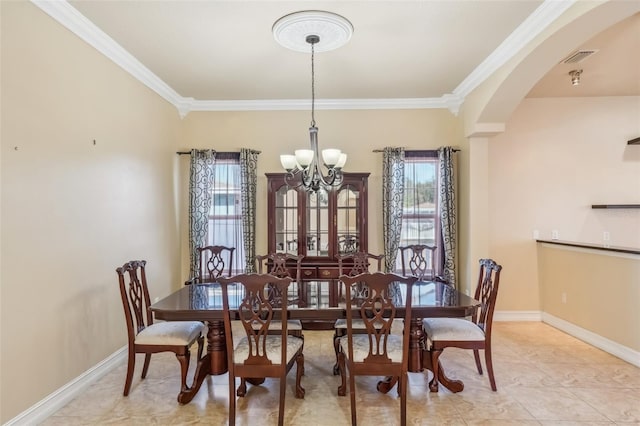 tiled dining space featuring ornamental molding and an inviting chandelier