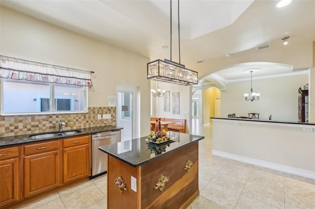 kitchen with decorative backsplash, stainless steel dishwasher, sink, decorative light fixtures, and a notable chandelier