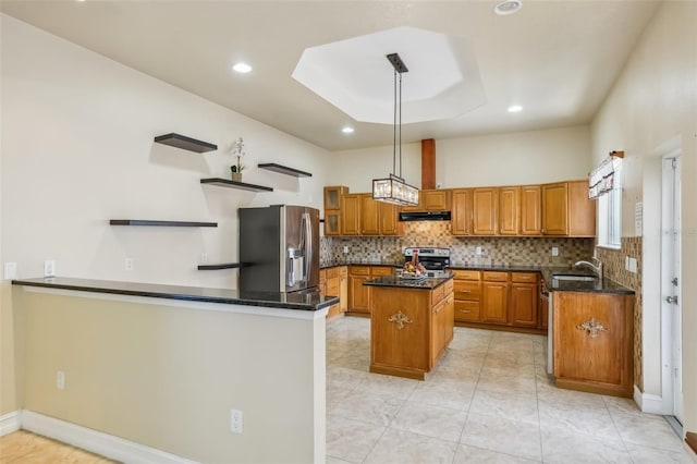 kitchen with a center island, sink, stainless steel appliances, dark stone counters, and pendant lighting