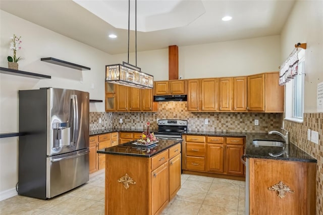 kitchen featuring sink, dark stone countertops, decorative light fixtures, a kitchen island, and appliances with stainless steel finishes