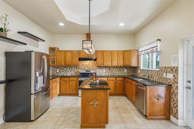 kitchen featuring sink, hanging light fixtures, dark stone counters, a kitchen island, and appliances with stainless steel finishes