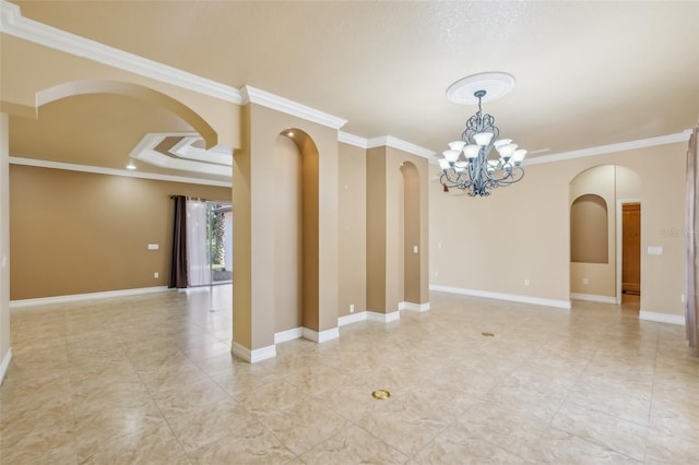 empty room with a tray ceiling, an inviting chandelier, and ornamental molding