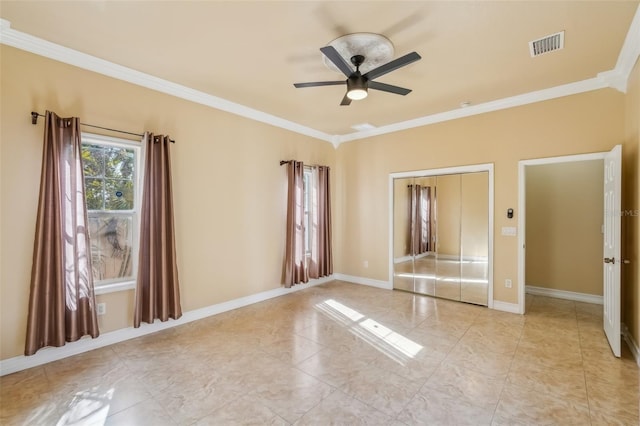 spare room featuring ceiling fan and ornamental molding